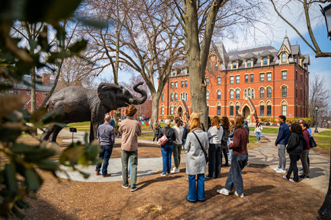 Visitors gather at the Jumbo statue during a campus tour.