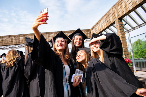 A group of graduates pose for a selfie