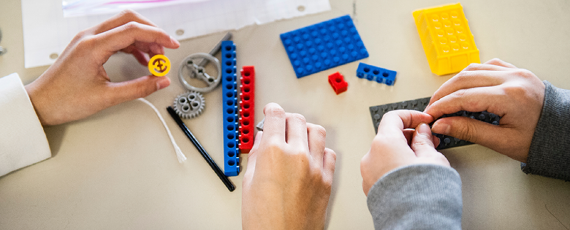Close-up shot of person building project with LEGO pieces