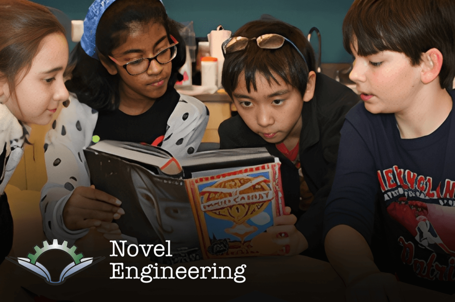 Students reading a book about engineering
