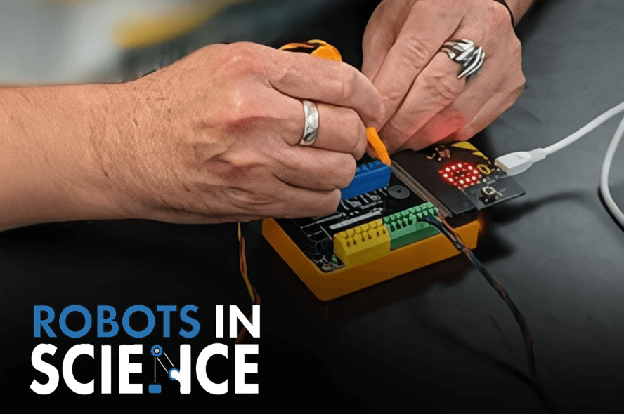 hands working on a robotics component