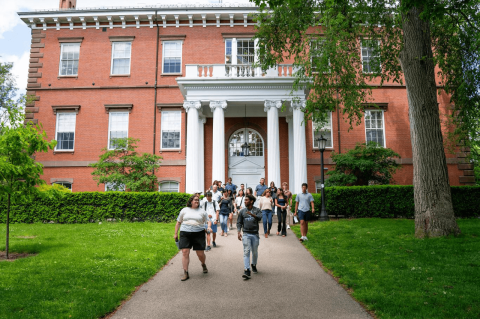 Students walk across The Green on a spring day.